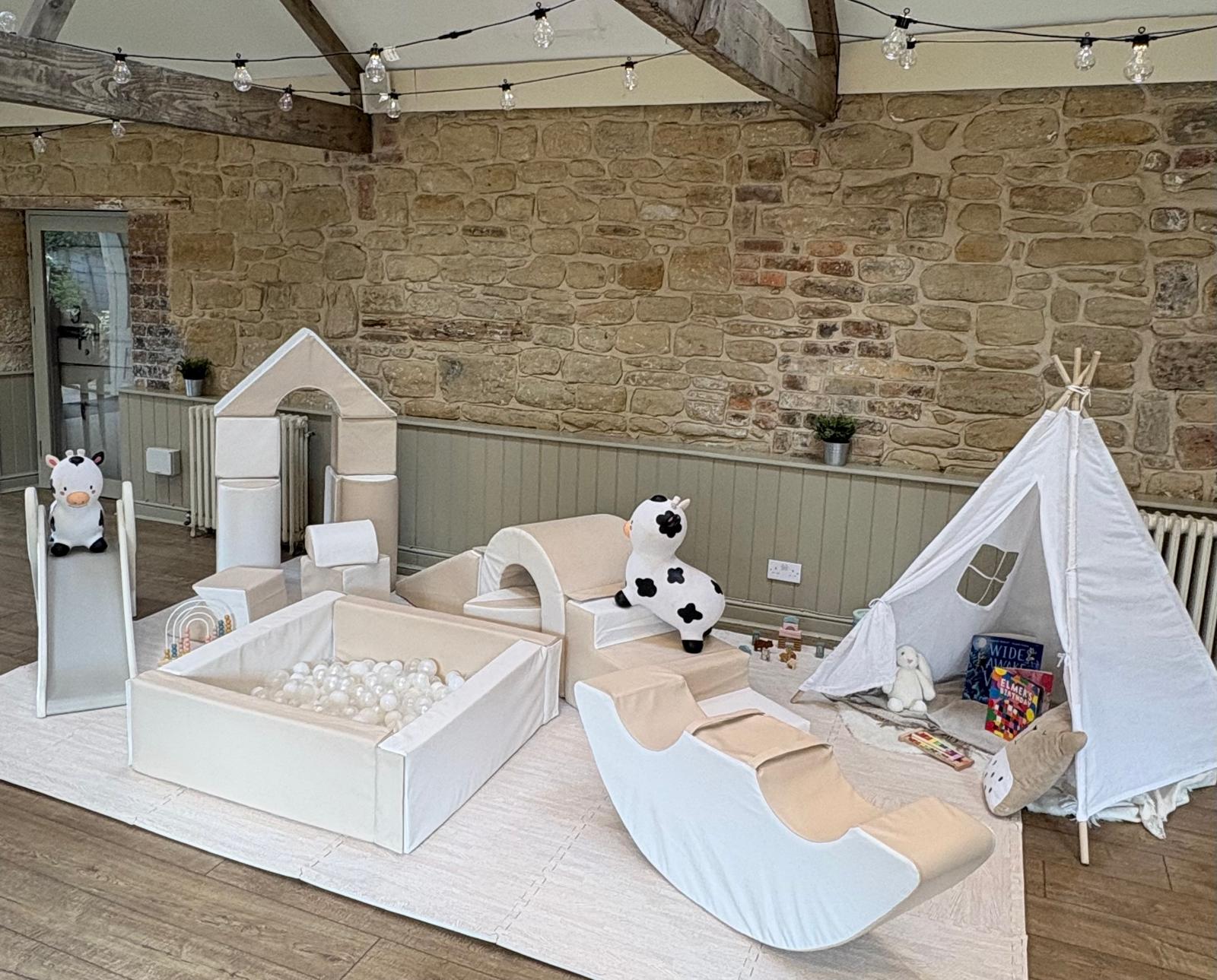 Little Lily Pad luxury soft play setup — ball pit, slide and teepee in a styled barn venue